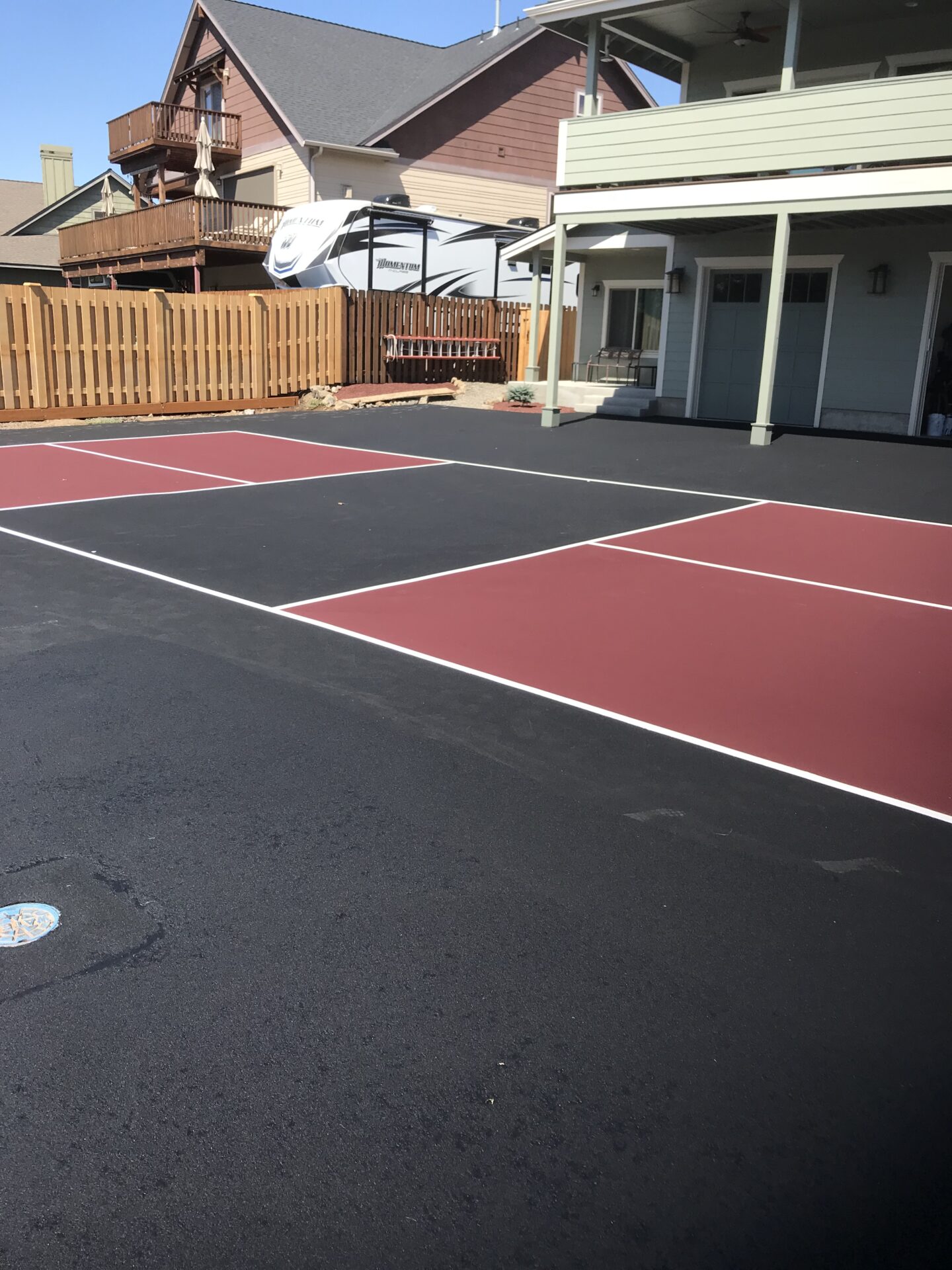 A tennis court with two different colors of asphalt.