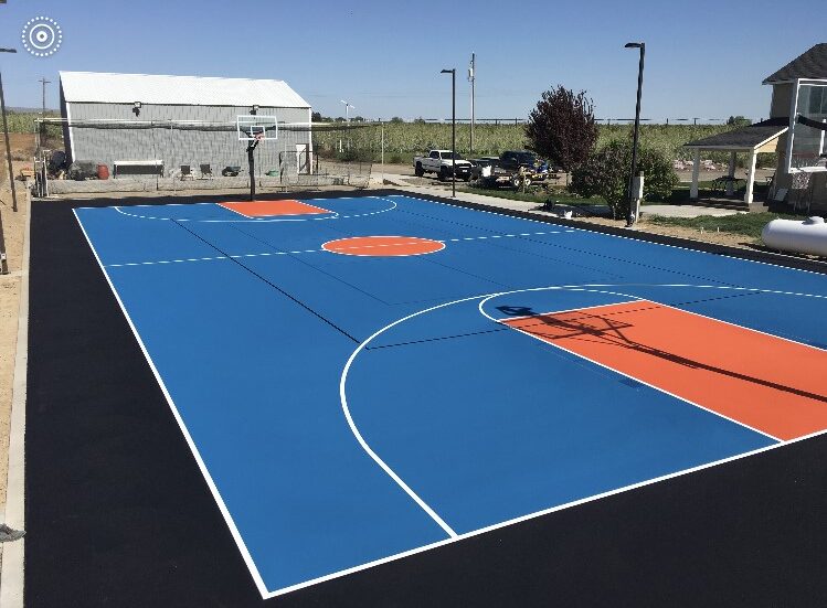 A basketball court with two different colors of blue and orange.