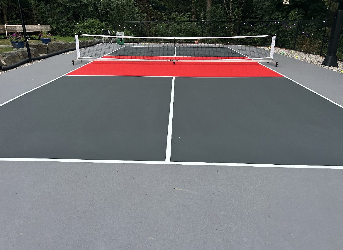 A tennis court with two different colors of the same color.